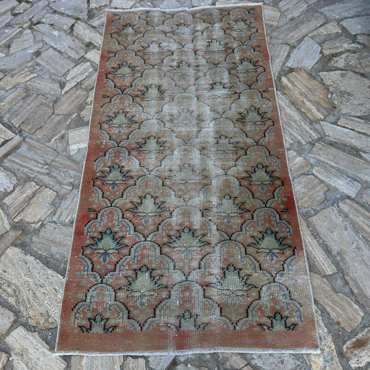 Pale Orange 3' x 7' vintage turkish rug in wool and cotton, shown on the floor.