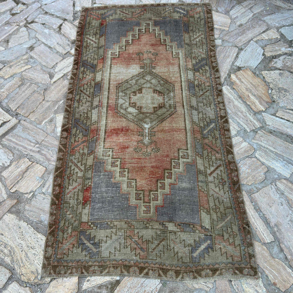 Pale Red 3' x 7' vintage turkish rug in wool and cotton, shown on the floor.