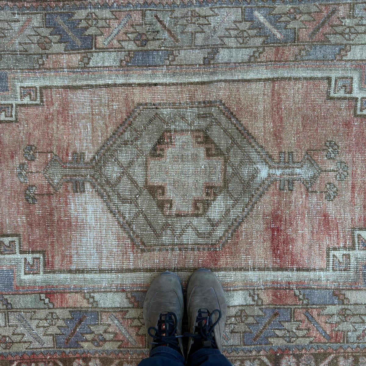 1970s pale red vintage turkish rug with traditional design, hand-knotted weave and low pile.