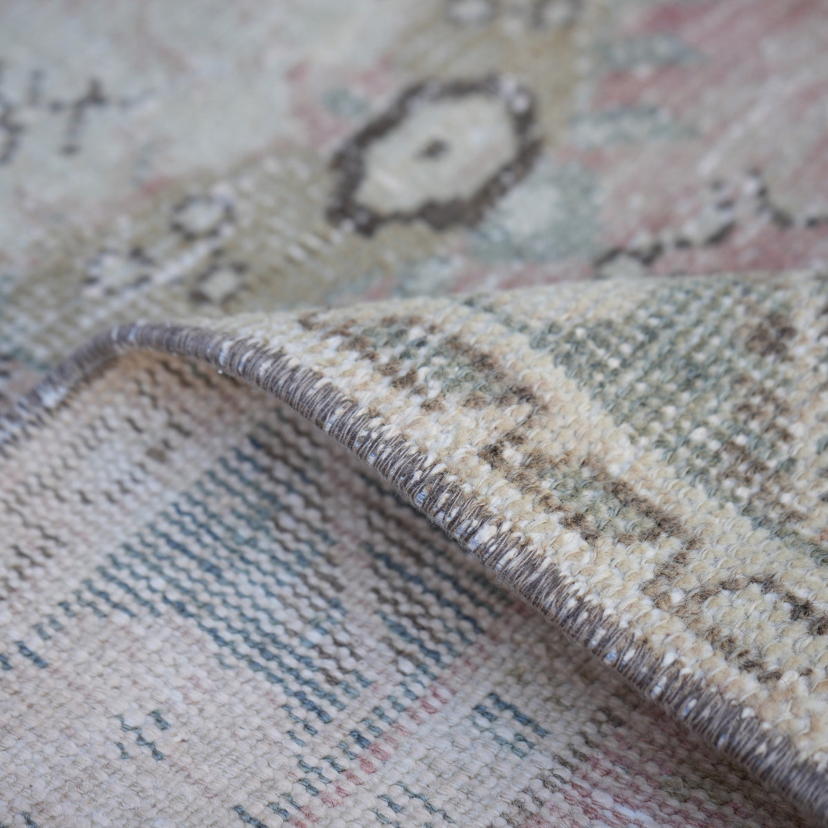 Additional view of the pale red vintage turkish rug, hand-knotted in wool and cotton.