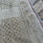 Close-up of the brown vintage turkish rug showing neutral details, hand-knotted weave, wool and cotton and low pile.