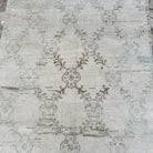 1970s beige vintage turkish rug with geometric design, hand-knotted weave and low pile.