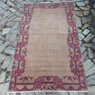 Beige 4' x 6' vintage turkish rug in wool and cotton, shown on the floor.