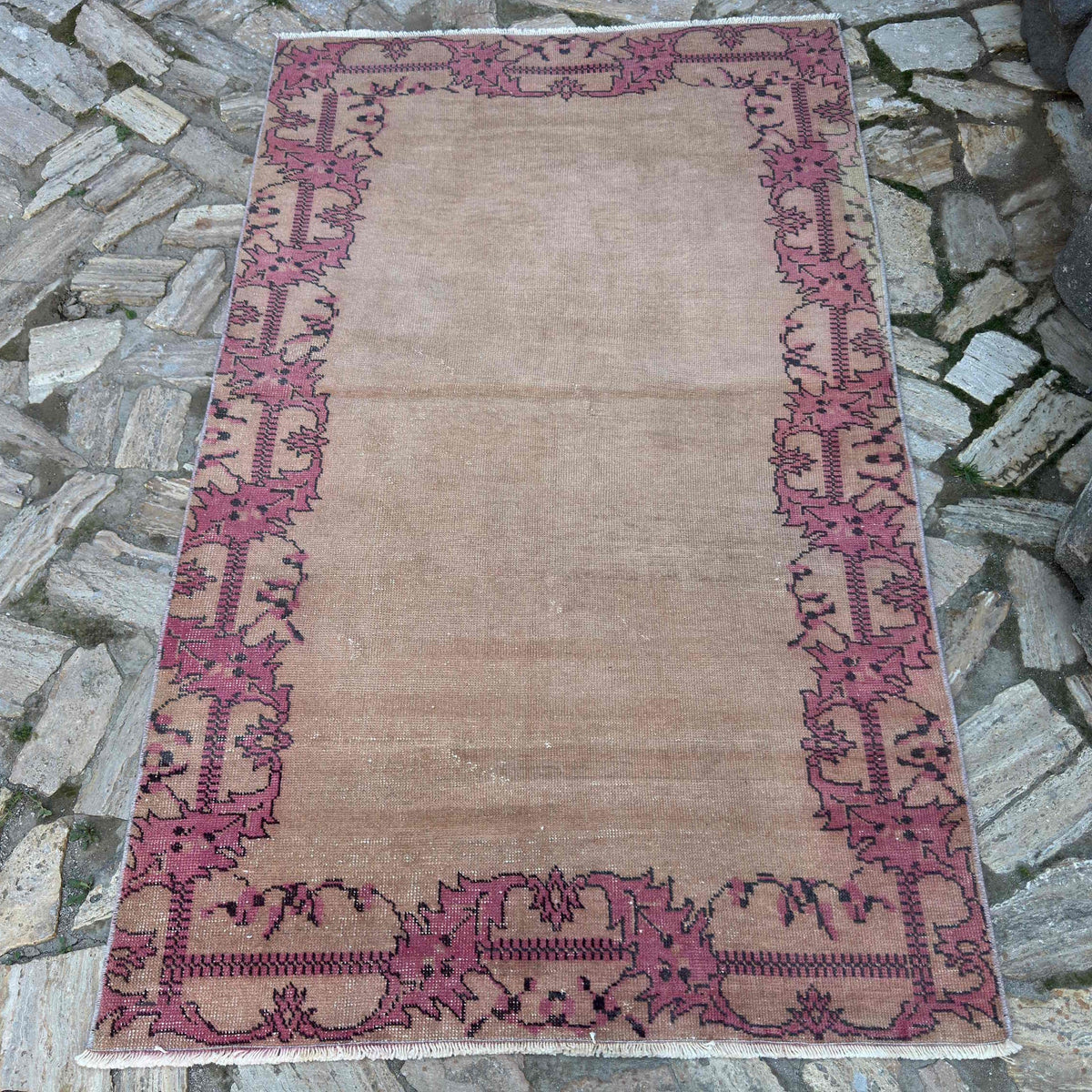 Beige 4' x 6' vintage turkish rug in wool and cotton, shown on the floor.