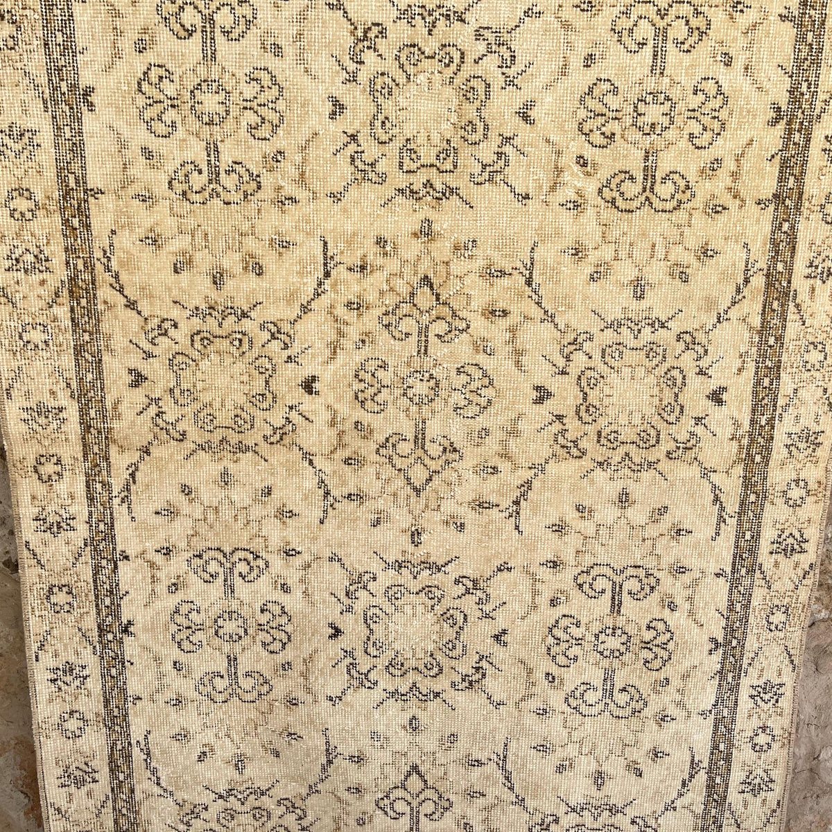 Brown 4' x 6' vintage turkish rug in wool and cotton, shown on the floor.