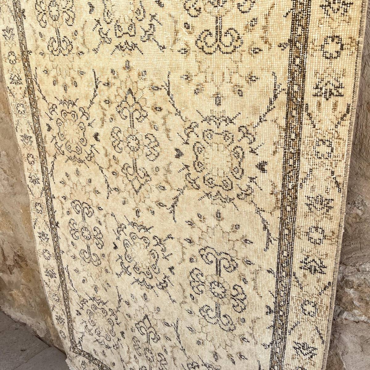1970s brown vintage turkish rug with neutral design, hand-knotted weave and low pile.