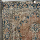 Orange 4' x 6' vintage turkish rug in wool and cotton, shown on the floor.