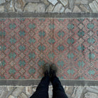1970s pale red vintage turkish rug with floral design, hand-knotted weave and low pile.