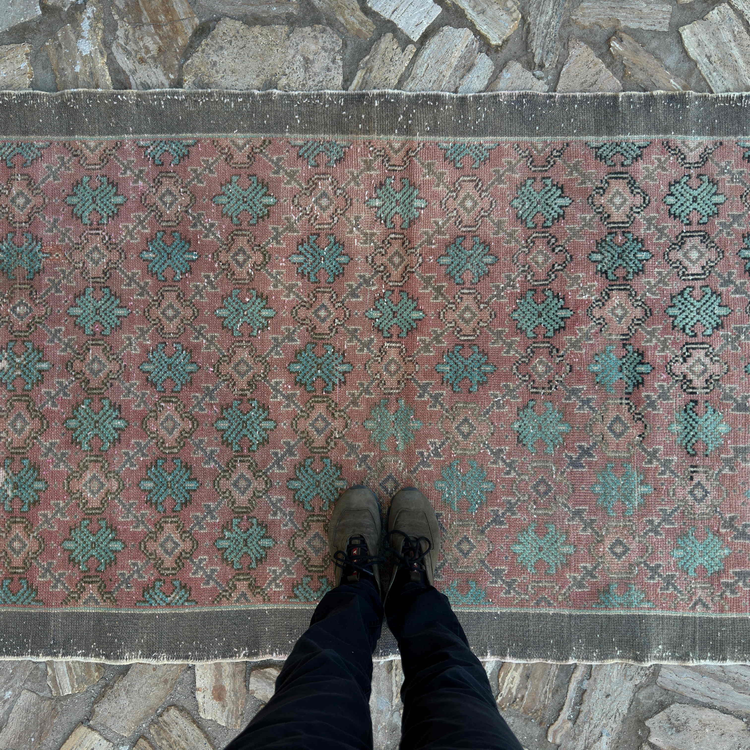 1970s pale red vintage turkish rug with floral design, hand-knotted weave and low pile.