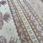 Close-up of the pink vintage turkish rug showing geometric details, hand-knotted weave, wool and cotton and low pile.