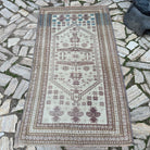 Pink 4' x 6' vintage turkish rug in wool and cotton, shown on the floor.