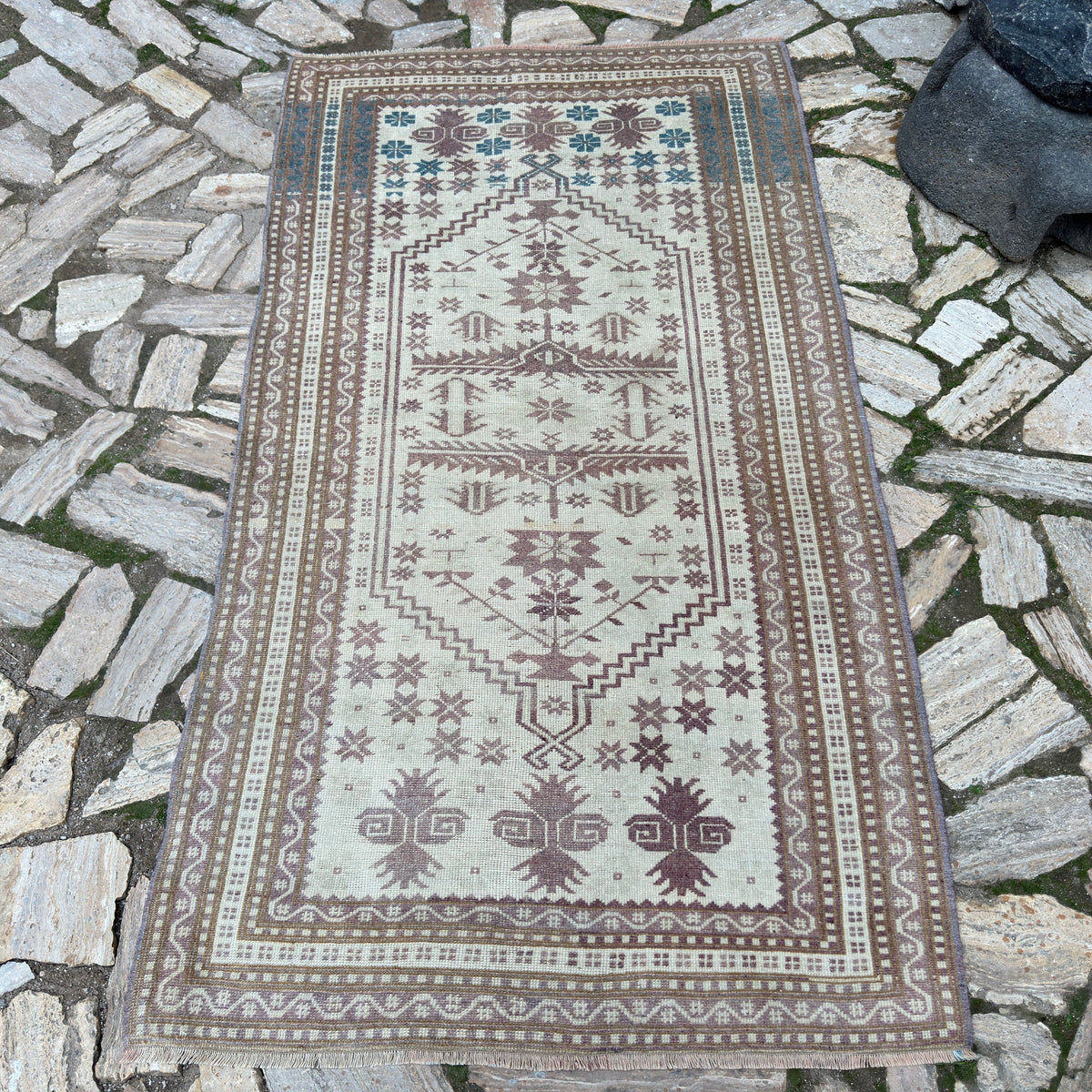 Pink 4' x 6' vintage turkish rug in wool and cotton, shown on the floor.
