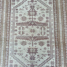 1970s pink vintage turkish rug with geometric design, hand-knotted weave and low pile.