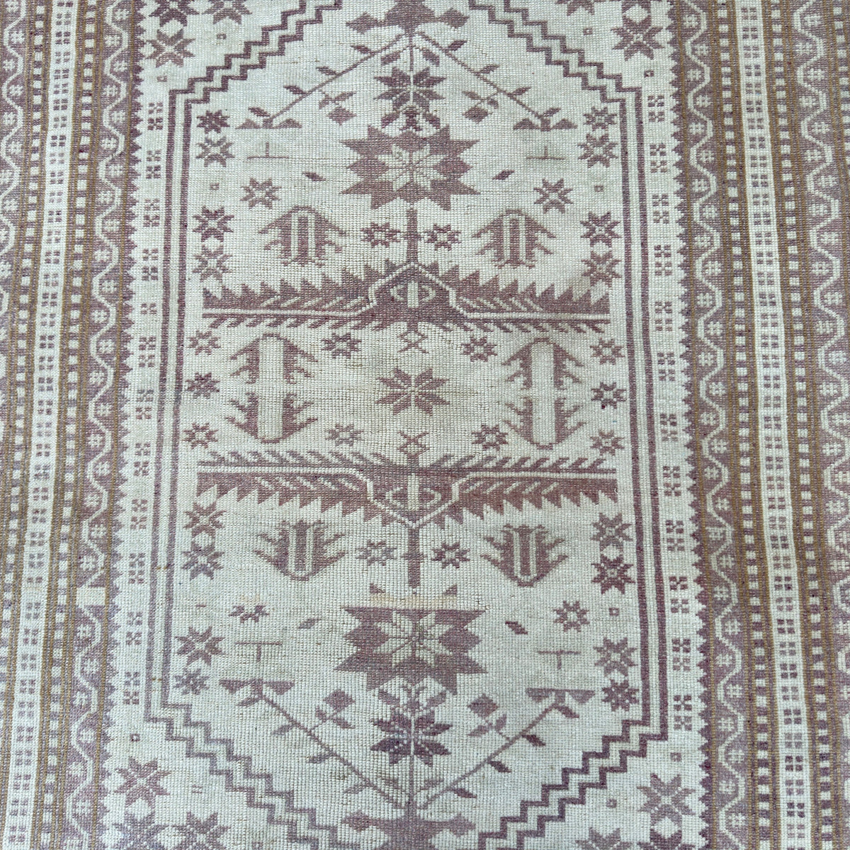1970s pink vintage turkish rug with geometric design, hand-knotted weave and low pile.