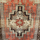 Red 4' x 6' vintage turkish rug in wool and cotton, shown on the floor.