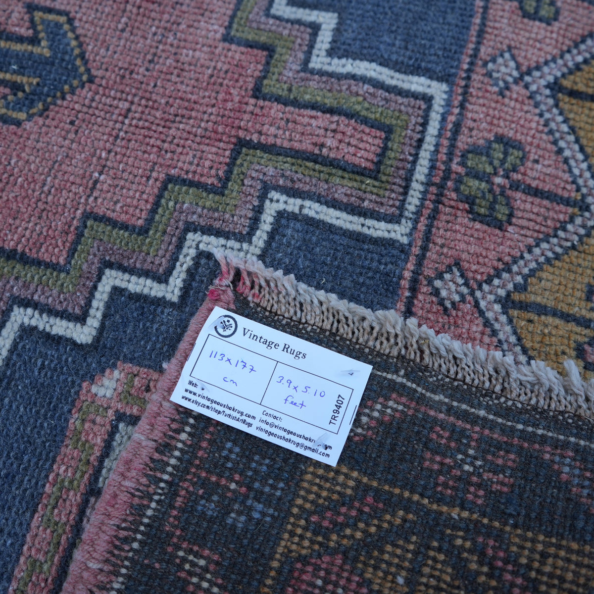 Red 4' x 6' vintage turkish rug from the 1970s with traditional design.