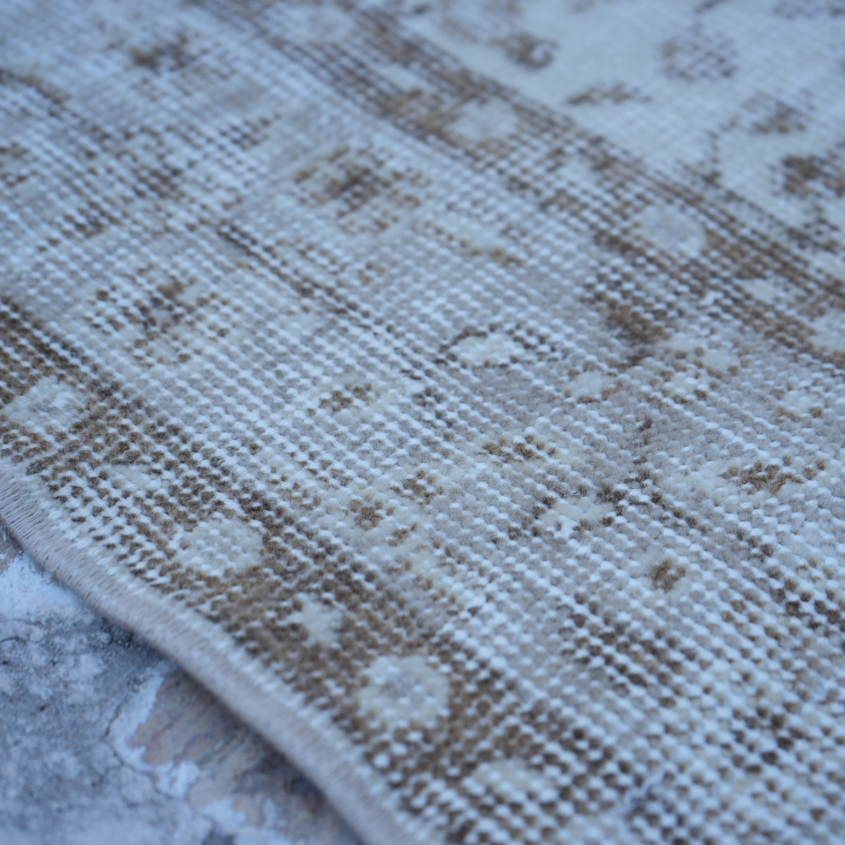 Beige 4' x 7' vintage turkish rug in wool and cotton, shown on the floor.