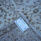 Beige 4' x 7' vintage turkish rug from the 1970s with neutral design.