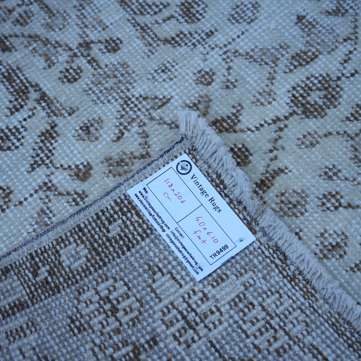 Beige 4' x 7' vintage turkish rug from the 1970s with neutral design.