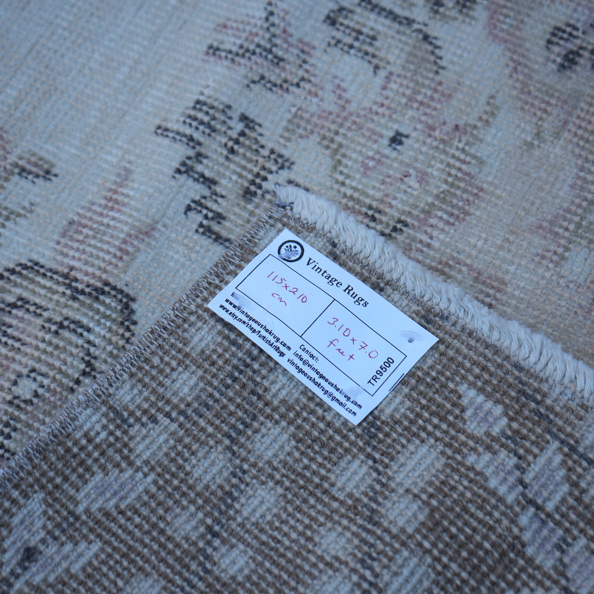Beige 4' x 7' vintage turkish rug from the 1970s with traditional design.