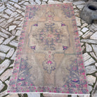Beige 4' x 7' vintage turkish rug in wool and cotton, shown on the floor.