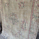 1970s beige vintage turkish rug with neutral design, hand-knotted weave and low pile.