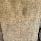 Beige 4' x 7' vintage turkish rug in wool and cotton, shown on the floor.