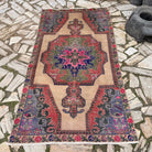 Blue 4' x 7' vintage turkish rug in wool and cotton, shown on the floor.