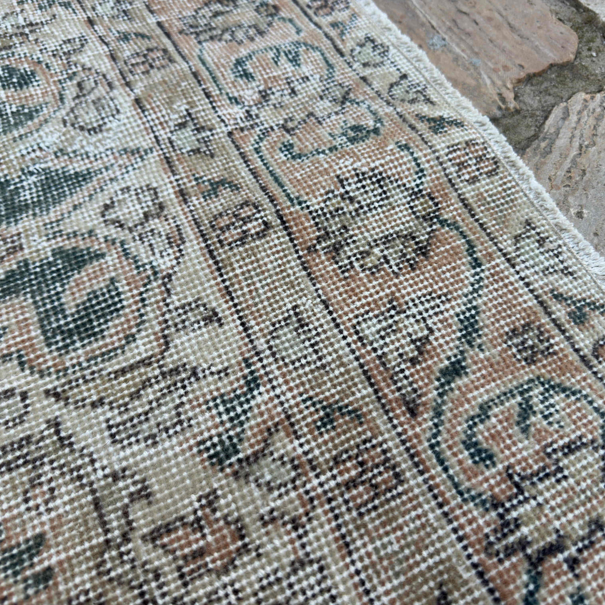 Close-up of the blue vintage turkish rug showing neutral details, hand-knotted weave, wool and cotton and low pile.