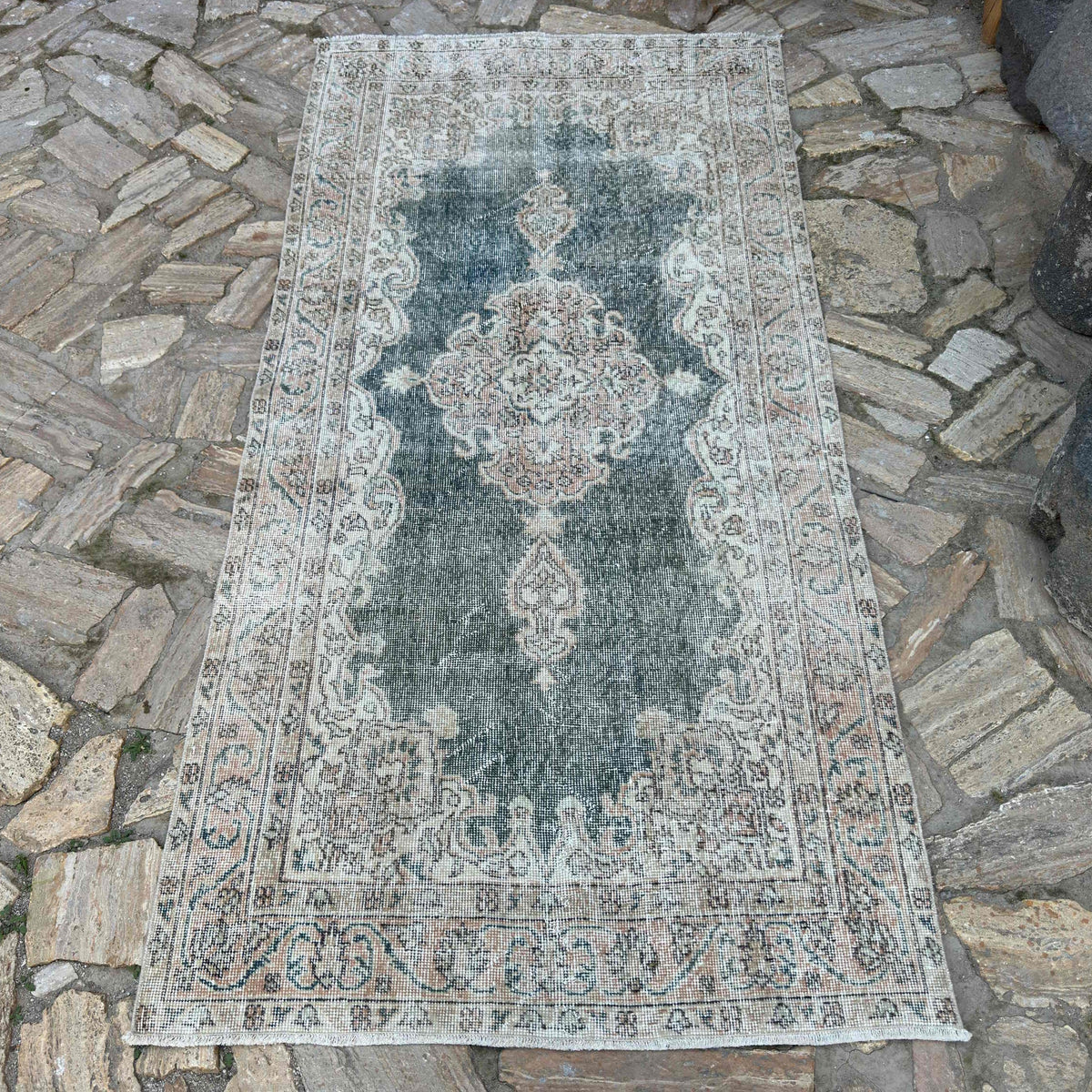 Blue 4' x 7' vintage turkish rug in wool and cotton, shown on the floor.