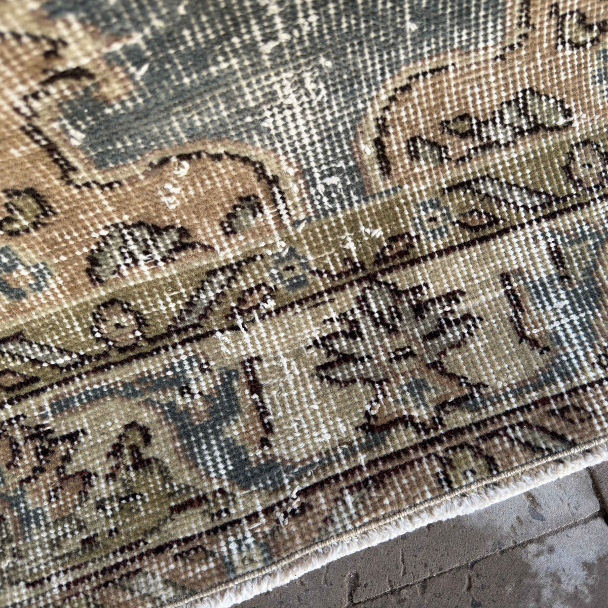 Close-up of the blue vintage turkish rug showing traditional details, hand-knotted weave, wool and cotton and low pile.