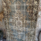 Blue 4' x 7' vintage turkish rug in wool and cotton, shown on the floor.