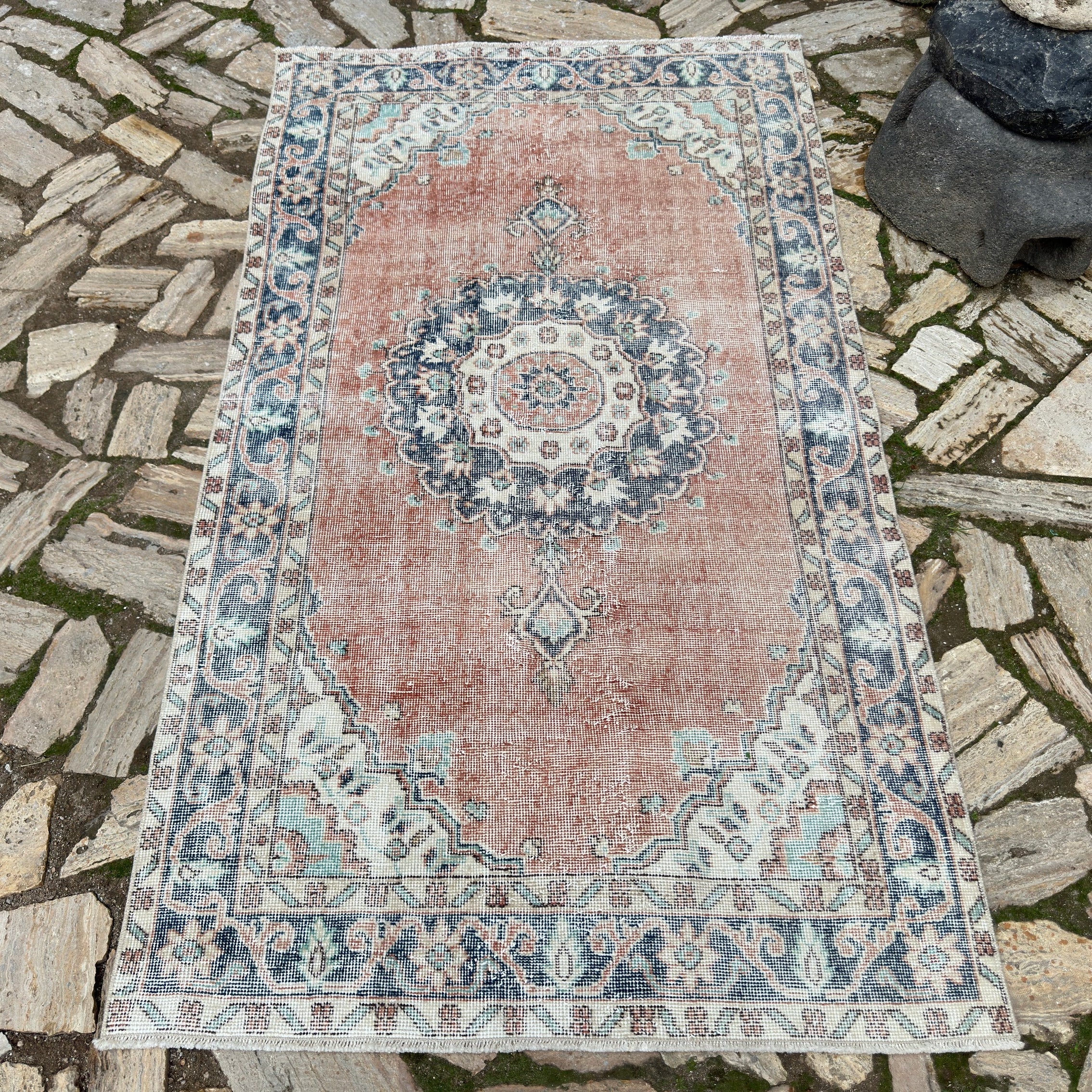 Blue 4' x 7' vintage turkish rug in wool and cotton, shown on the floor.