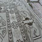 Close-up of the gray vintage turkish rug showing neutral details, hand-knotted weave, wool and cotton and low pile.