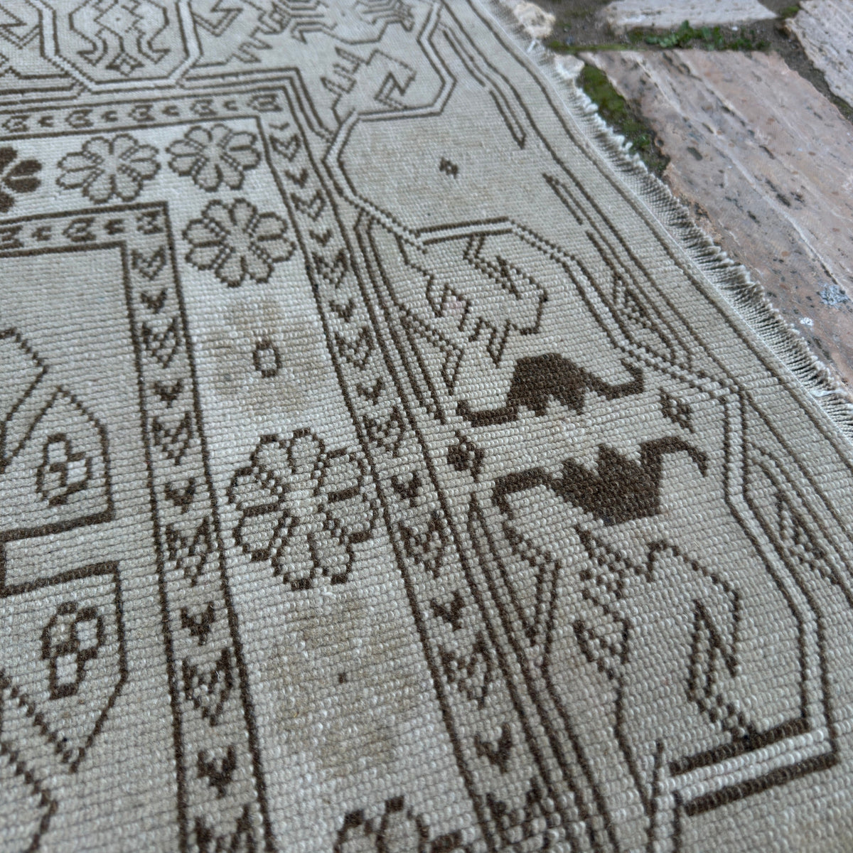 Close-up of the gray vintage turkish rug showing neutral details, hand-knotted weave, wool and cotton and low pile.