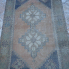 Close-up of the orange vintage turkish rug showing traditional details, hand-knotted weave, wool and low pile.