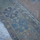 Orange 4' x 7' vintage turkish rug in wool, shown on the floor.