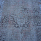 Close-up of the pale orange vintage turkish rug showing neutral details, hand-knotted weave, wool and cotton and low pile.