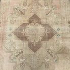 1970s pale pink vintage turkish rug with medallion design, hand-knotted weave and low pile.