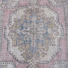 1970s pale pink vintage turkish rug with traditional design, hand-knotted weave and low pile.