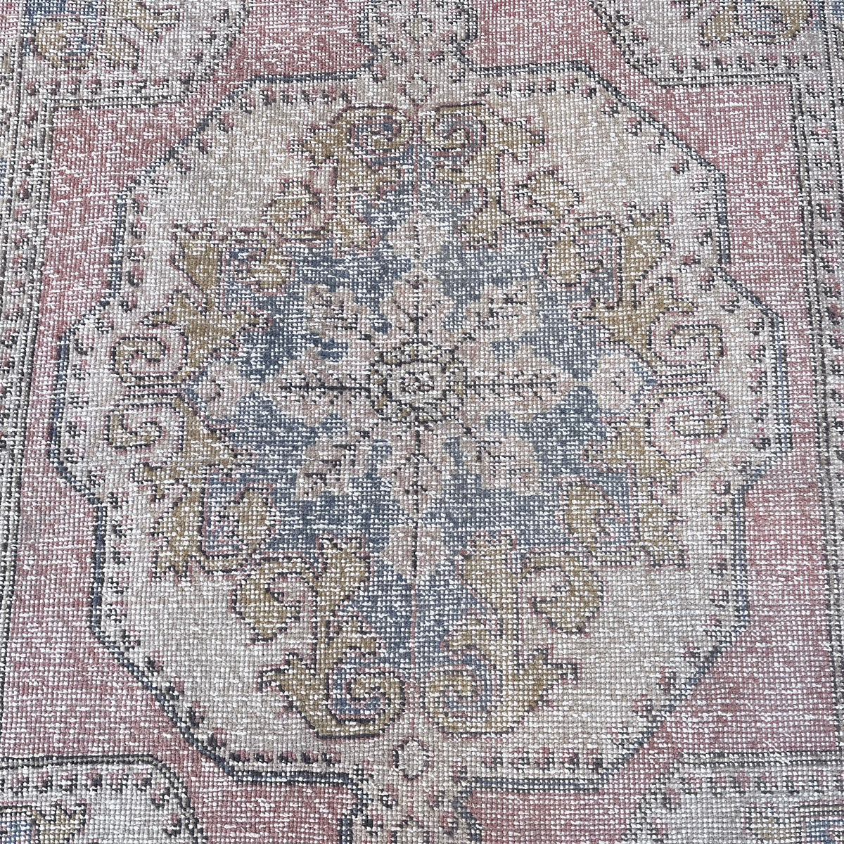 1970s pale pink vintage turkish rug with traditional design, hand-knotted weave and low pile.