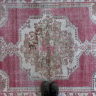 1970s pale red vintage turkish rug with traditional design, hand-knotted weave and low pile.