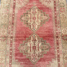 1970s pink vintage turkish rug with medallion design, hand-knotted weave and low pile.