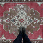 1970s red vintage turkish rug with medallion design, hand-knotted weave and low pile.