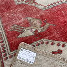Close-up of the red vintage turkish rug showing traditional details, hand-knotted weave, wool and cotton and low pile.