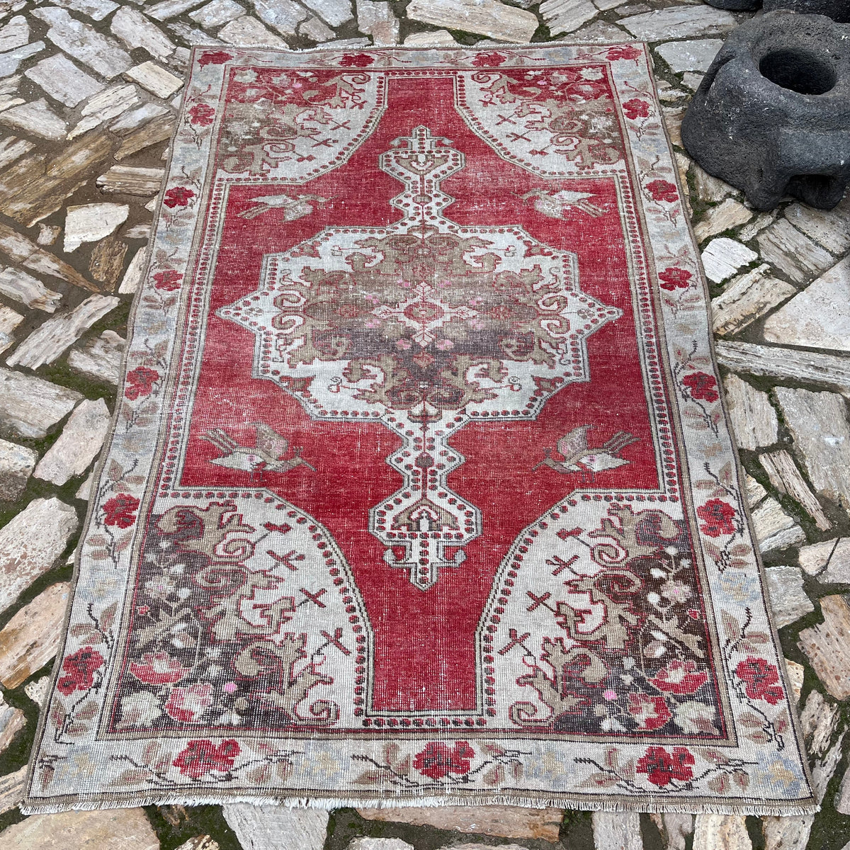 Red 4' x 7' vintage turkish rug in wool and cotton, shown on the floor.