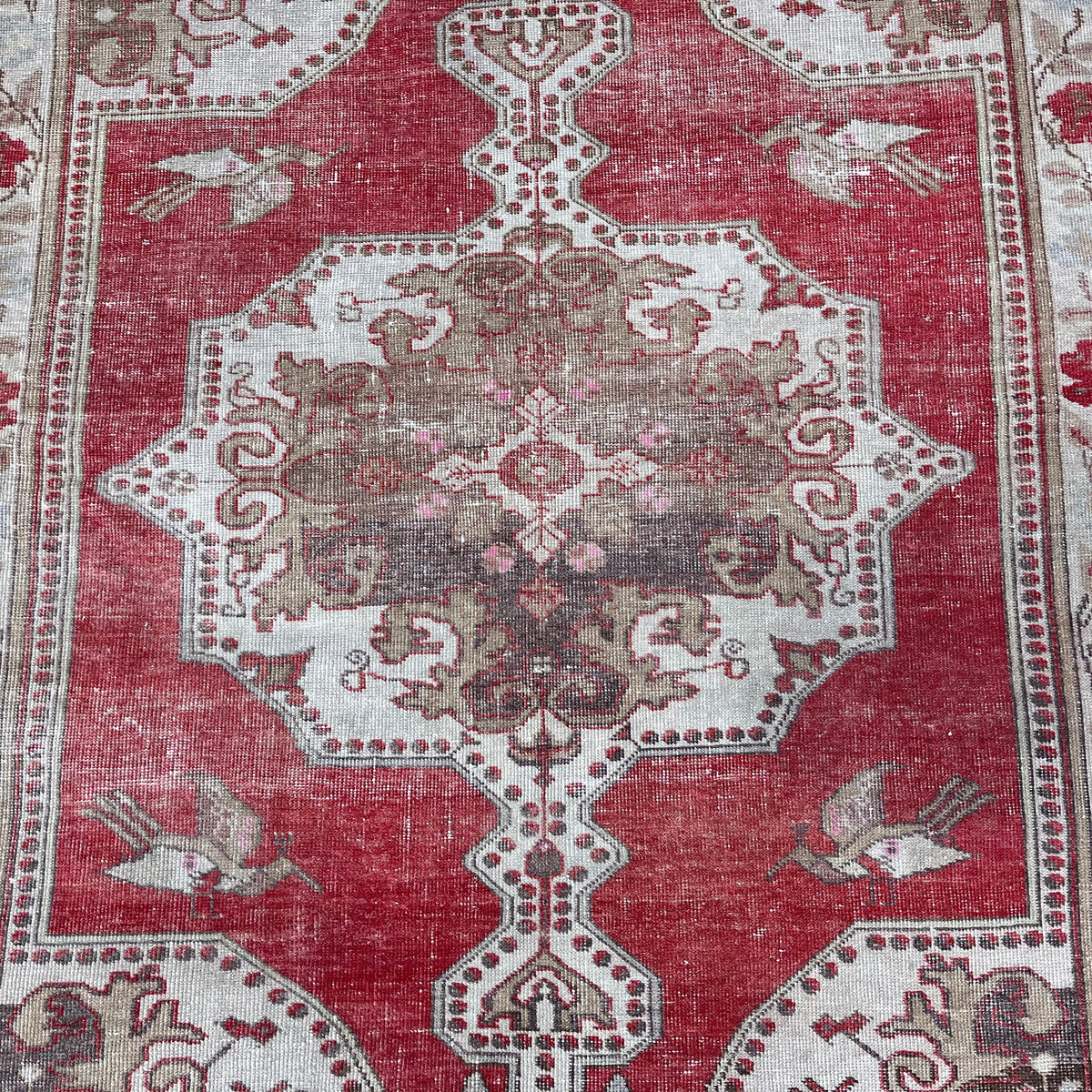 1970s red vintage turkish rug with traditional design, hand-knotted weave and low pile.
