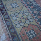 Red 4' x 7' vintage turkish rug in wool, shown on the floor.