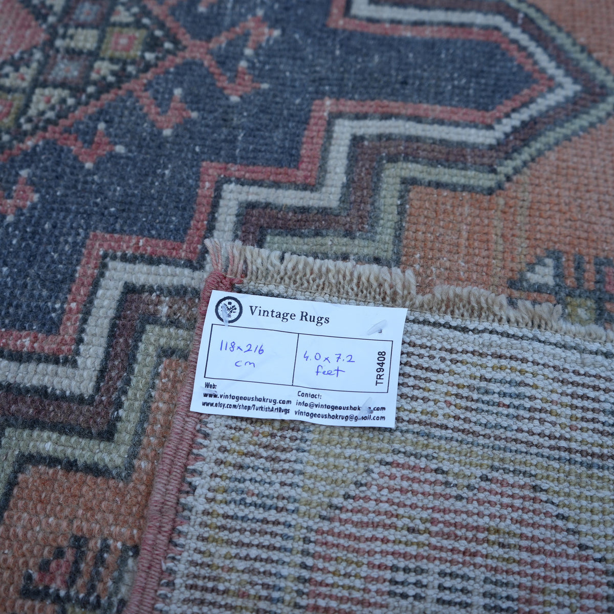 Red 4' x 7' vintage turkish rug from the 1970s with traditional design.