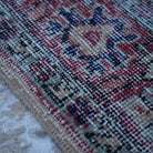 Red 4' x 7' vintage turkish rug in wool and cotton, shown on the floor.